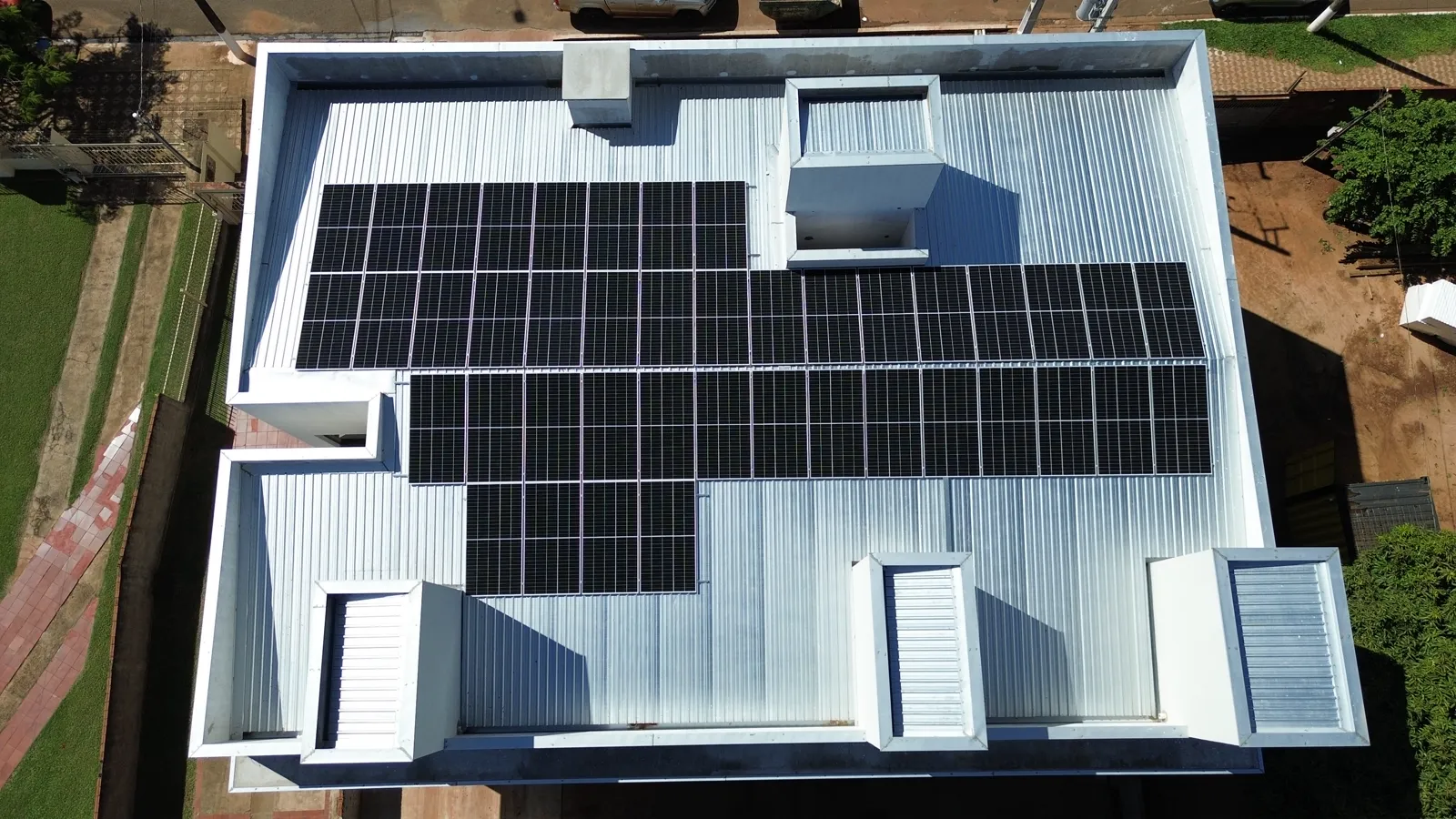 Vista aérea de painéis solares instalados pela EVT Engenharia em telhado metálico